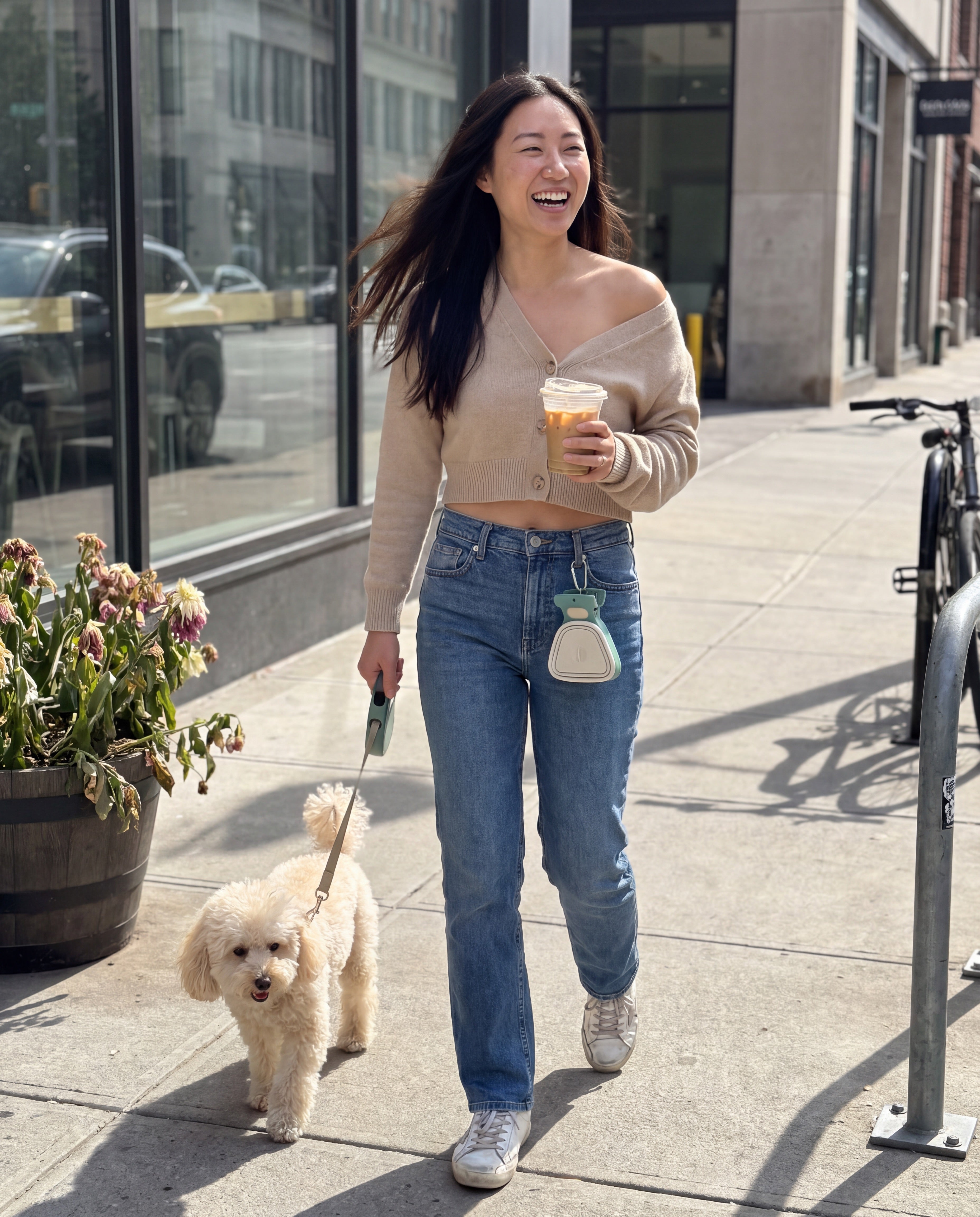 Dog parent mid-walk with Scoopy clipped to jeans